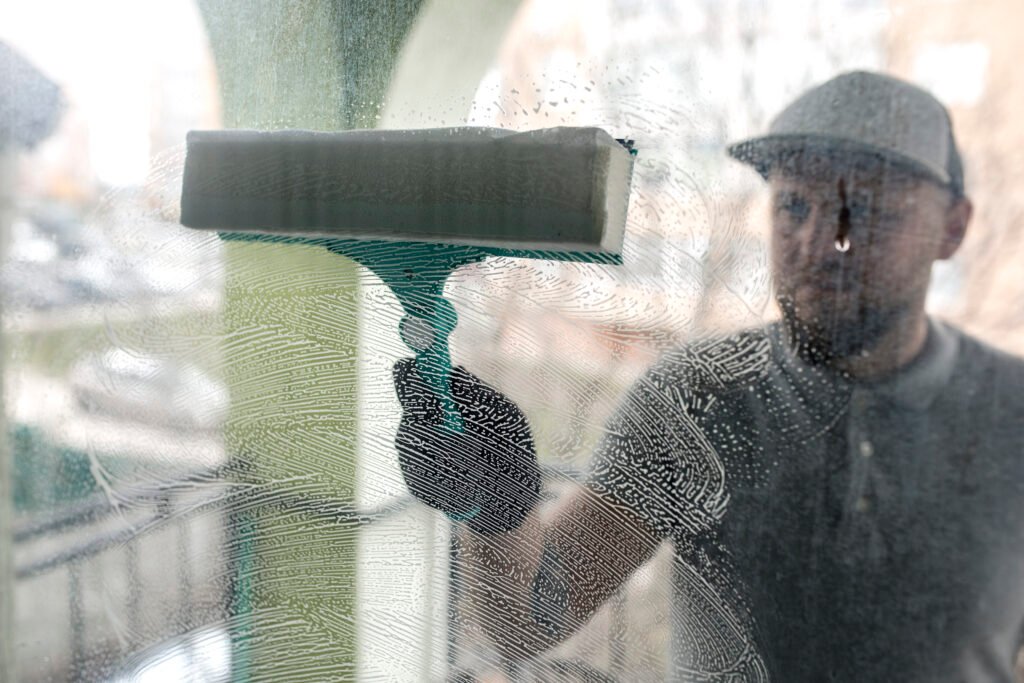 Person professionaly cleaning window