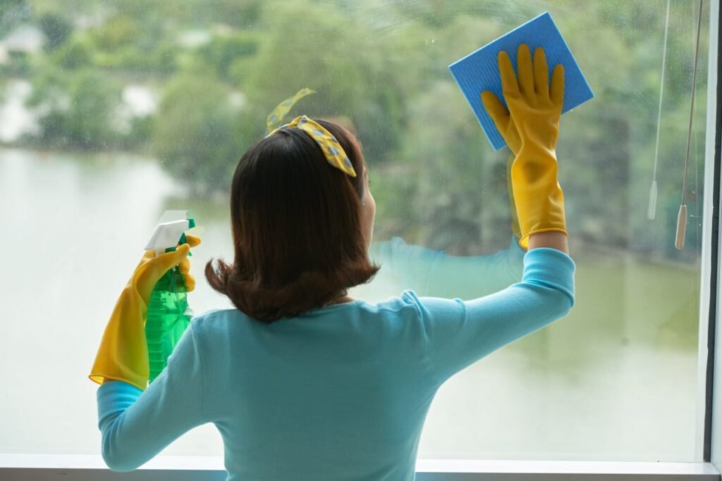 woman cleaning window