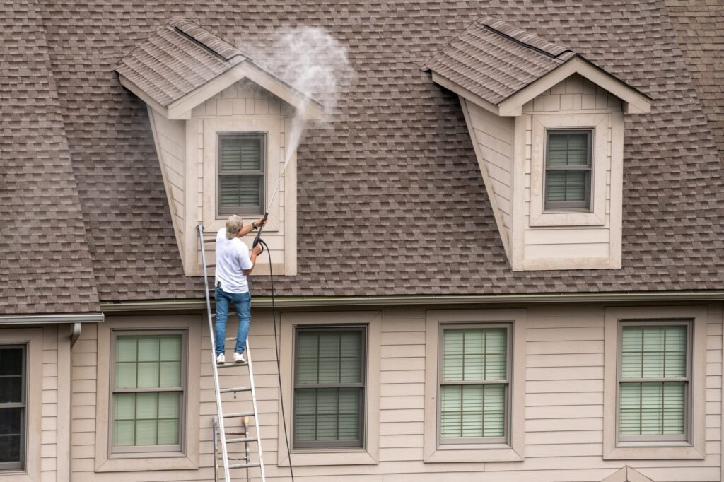 worker-ladder-pressure-washing-home-prior-painting (1) (1) house being power washed after used company exterior cleaning offers