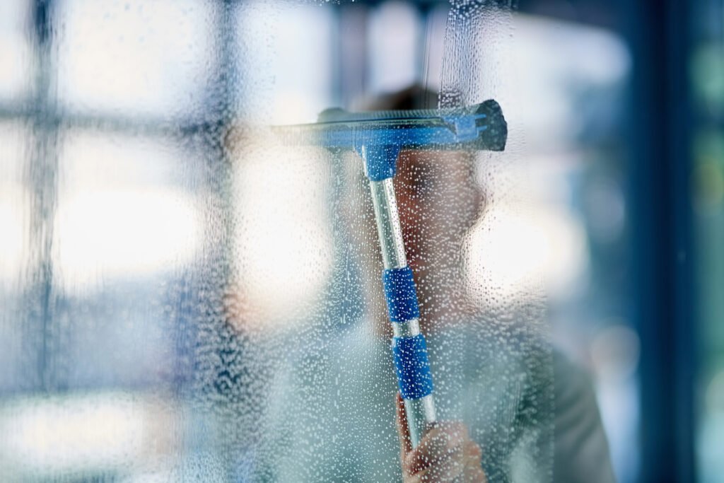 young man cleaning windows