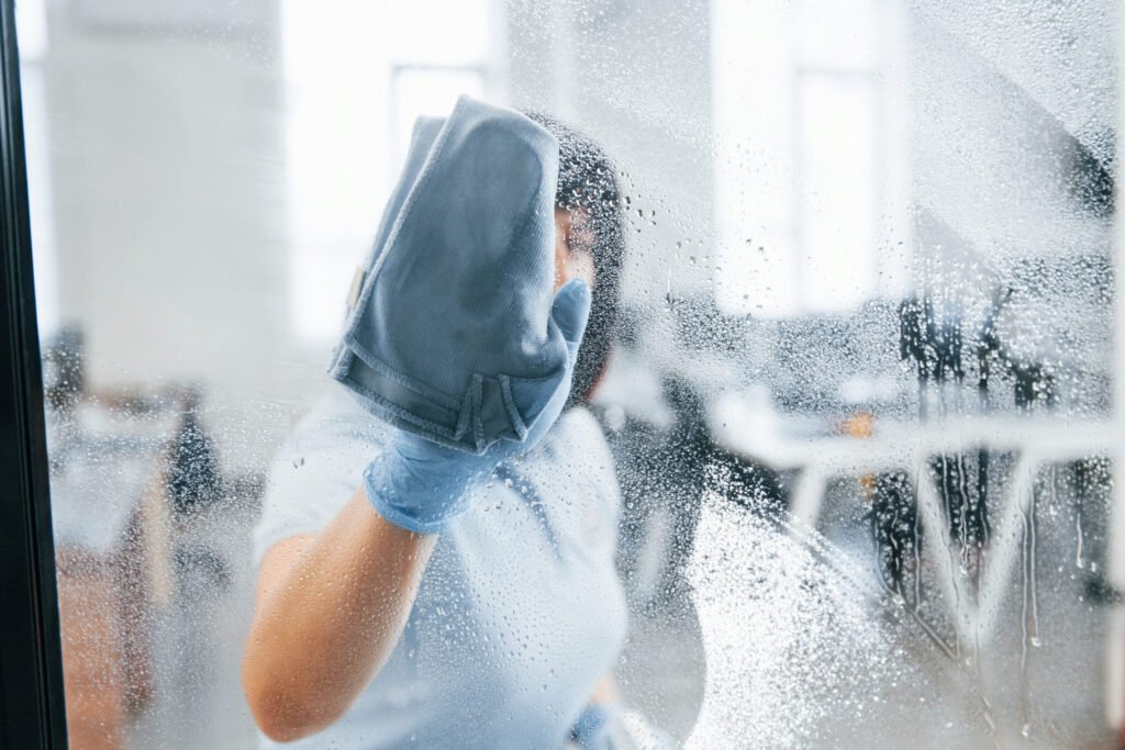 woman cleaning a window